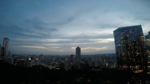 Shinjuku, Tokyo time-lapse at dusk, aerial Stock Footage