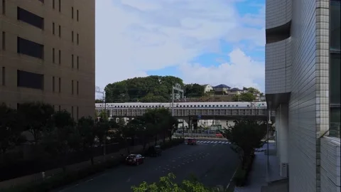 Shinkansen, bullet train, passes between building at Shinyokohama station. Stock Footage 138869073