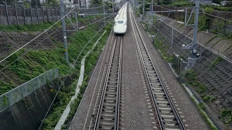 Shinkansen, bullet train, passes under the railway overpass at full speed Stock Footage 138868960