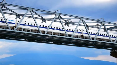 Shinkansen A high-speed train on a bridge over the river. pass mt. fuji at .. Stock Footage 75217426