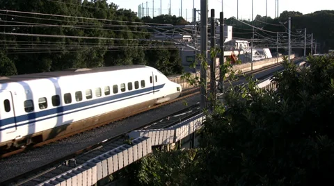 Shinkansen Train leaving Tokyo, passing a bridge. Stock-Footage 36007646