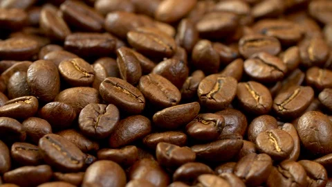 Shiny and fragrant brown roasted coffee beans on a rotating panel. Background Stock Footage 101367853