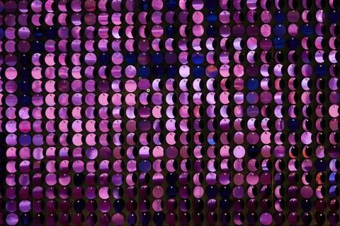 Shiny background texture, a set of round purple sequins like fish scales Stock Photos