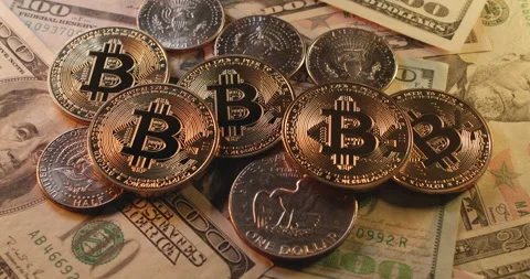 Shiny Bitcoin coins on half Dollar coins from USA. Trading crypto Bitcoin Stock Footage 176752387