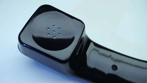 Shiny black handset with cable of old push-button telephone shines in darkness  Stock Footage 287932705