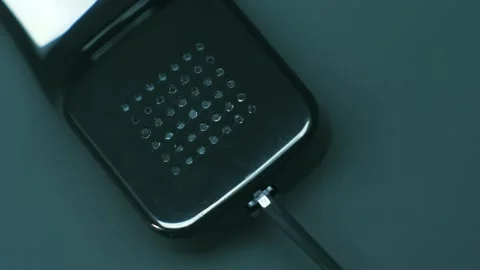 Shiny black handset with cable of old push-button telephone shines in darkness Stock Footage 287947875