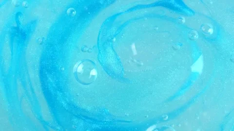 Shiny blue gel fluid with bubbles, rotating. Macro texture of cosmetics produ Stock Footage 276484970