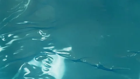 Shiny blue plastic sheet texture background with light reflections wrinkles.. Stock Footage 340581344