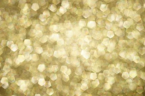 Shiny blurred gold background with pentagonal bubbles Stock Photos