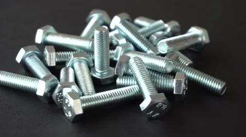 Shiny bolts rotating on a black background. Seamless loop. Prores 4K Stock Footage 66845239