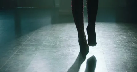 Shiny boots walking into spotlight Stock Footage 247523897