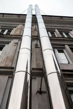 Shiny chimneys attached to building Stock Photos