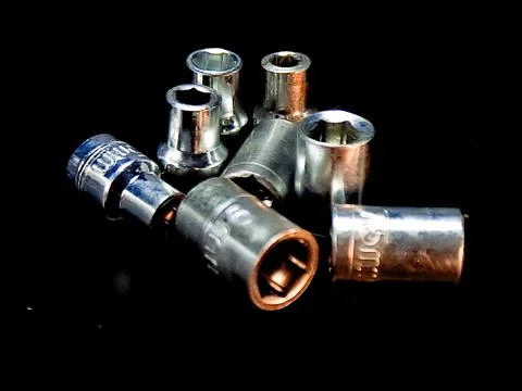 Shiny, chrome socket set arranged on a black surface, offering an industria.. Stock Photos