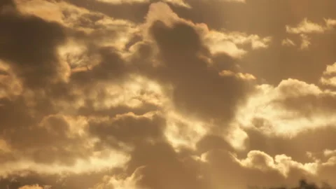Shiny clouds on yellowish sky Stock Footage 99824345
