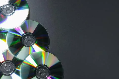 Shiny compact discs on grey background, top view. Space for text Stock Photos