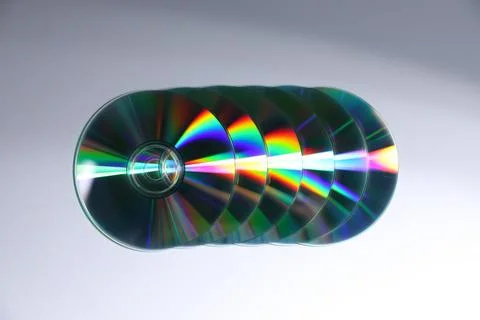 Shiny compact discs on light background, top view Stock Photos