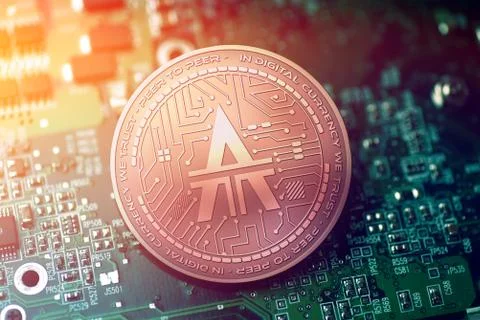 Shiny copper LA TOKEN cryptocurrency coin on blurry motherboard background Stock Illustration