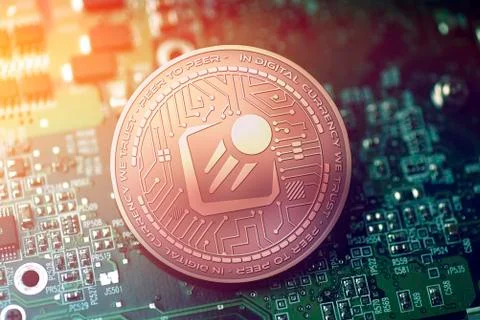Shiny copper STARTA cryptocurrency coin on blurry motherboard background Stock-Illustration