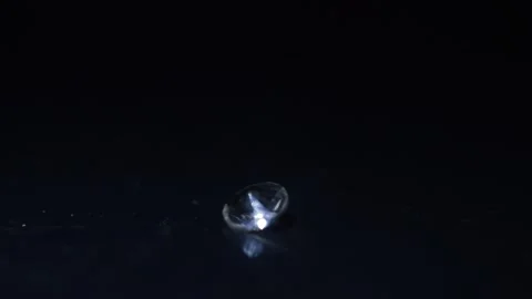 Shiny diamant crystal in a black background. light in motion on the diamant. Video stock 225863596