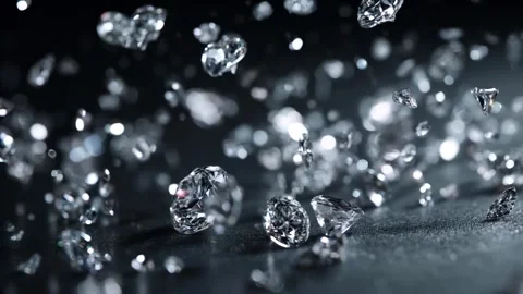 Shiny diamonds gracefully fall from above against a deep black background Video stock 314648964