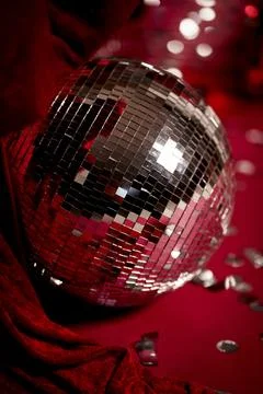 Shiny disco ball on red background with festive reflections 스톡 사진