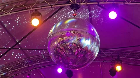 Shiny Disco Ball Under the Ceiling with Bright Stage Lights Stock Footage 341623788