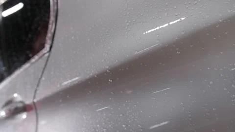 The shiny door handle of the rear left door of a gray wet car. Video stock 240730607