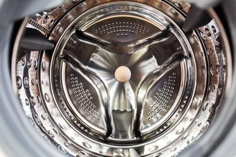 Shiny drum of washing machine inside Stock Photos