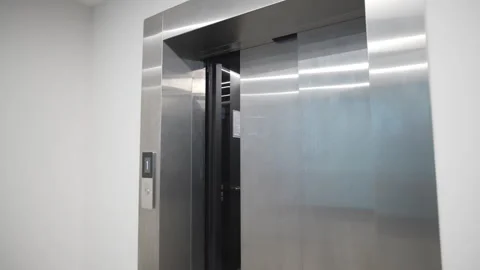 Shiny elevator door slowly closes ensuring passenger safety Stock Footage 324908533