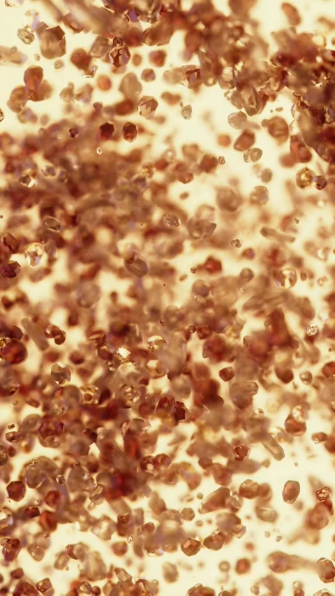 Shiny gems and particles move around in a warm red fire stone setting Stock Footage 344979254