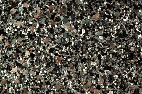 Shiny glitter texture on dark background close-up Stock-Fotos