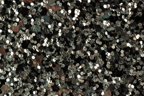 Shiny glitter texture on dark background close-up Stock-Fotos