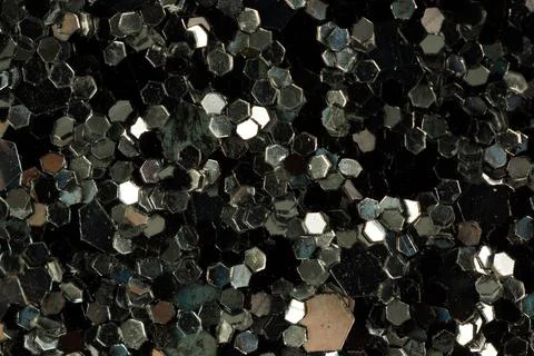 Shiny glitter texture on dark background close-up Stock-Fotos