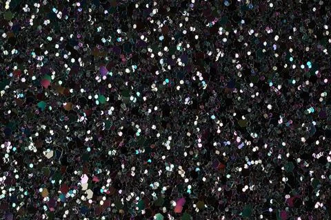 Shiny glitter texture on dark background close-up 스톡 사진