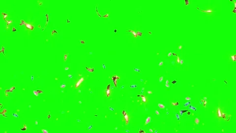 Shiny gold confetti particles falling downwards against a vibrant bright green 動画素材 344647362