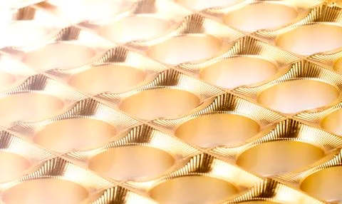 The shiny gold plastic background as texture of the empy candy box 스톡 사진