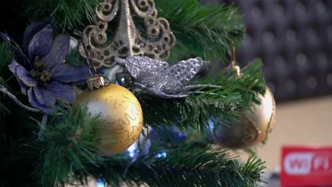Shiny golden bauble on the artificial tree in office. Gold color. New Year and Stock Footage 138992497