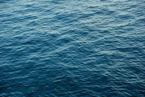 Shiny gradient blue sea surface with small waves and light reflection on th.. Stock Photos