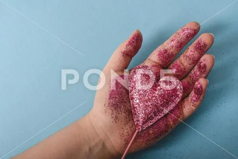 Shiny heart in hand Stock Photos