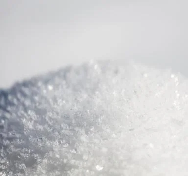 Shiny ice structures on snow after a freezing night in the Eifel, Germany. Stock Photos
