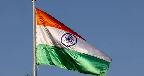 Shiny Indian flag against blue sky background Stock Footage 246727686