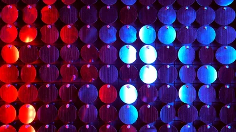 Shiny kinetic surface panel illuminated by red purple light in luxury boutique Stock Footage 114421453