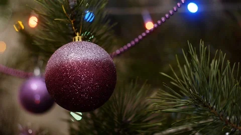 A shiny lilac ball with a pattern hangs on a Christmas tree Stock Footage 121848088