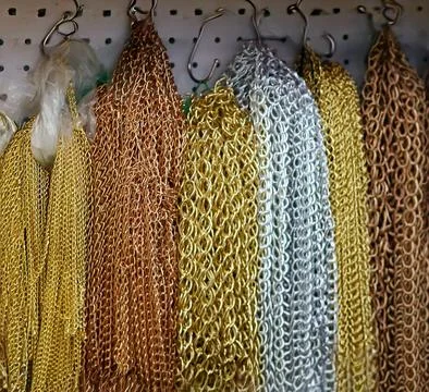 Shiny metal chains pattern background  hanging on wall in art and craft shop Stock Photos