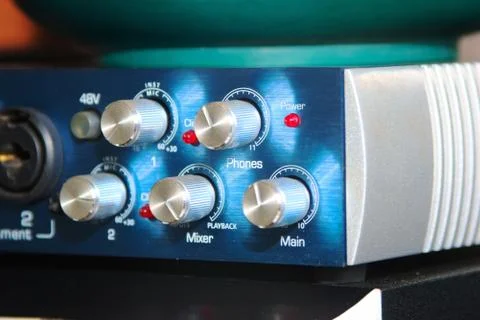 Shiny metal knobs on a sound mixing console. Extreme close up. Stock Photos