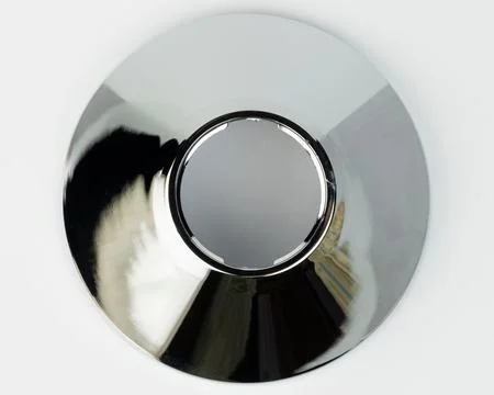 Shiny metal object with a circular shape and center hole Stock Photos