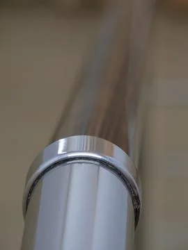 Shiny metal pipe. Angular connection on a stainless steel pipe. Background im Stock Photos