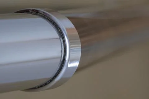 Shiny metal pipe close-up. Angular connection on a stainless steel pipe. Back Fotos de archivo