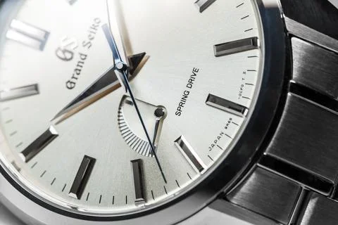 Shiny metallic clock face of automatic wrist watch Grand Seiko Stock Photos