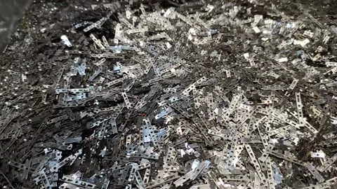 Shiny metallic sequins fall on the pile. Shine of silver particles. Art Stock Footage 163064826